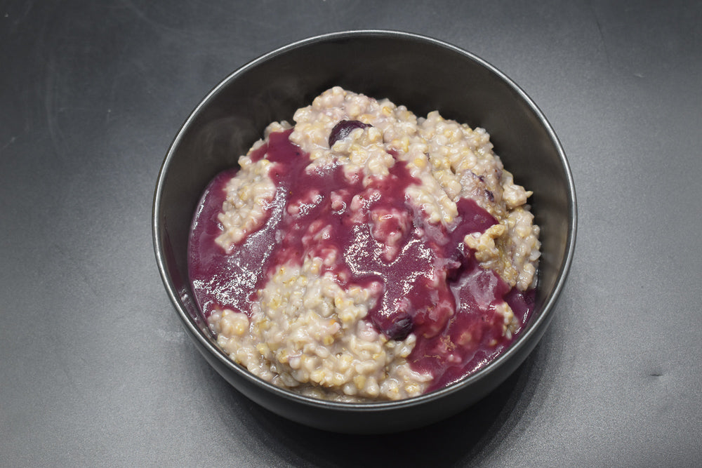 Gluten free blueberry oatmeal with coconut berry sauce